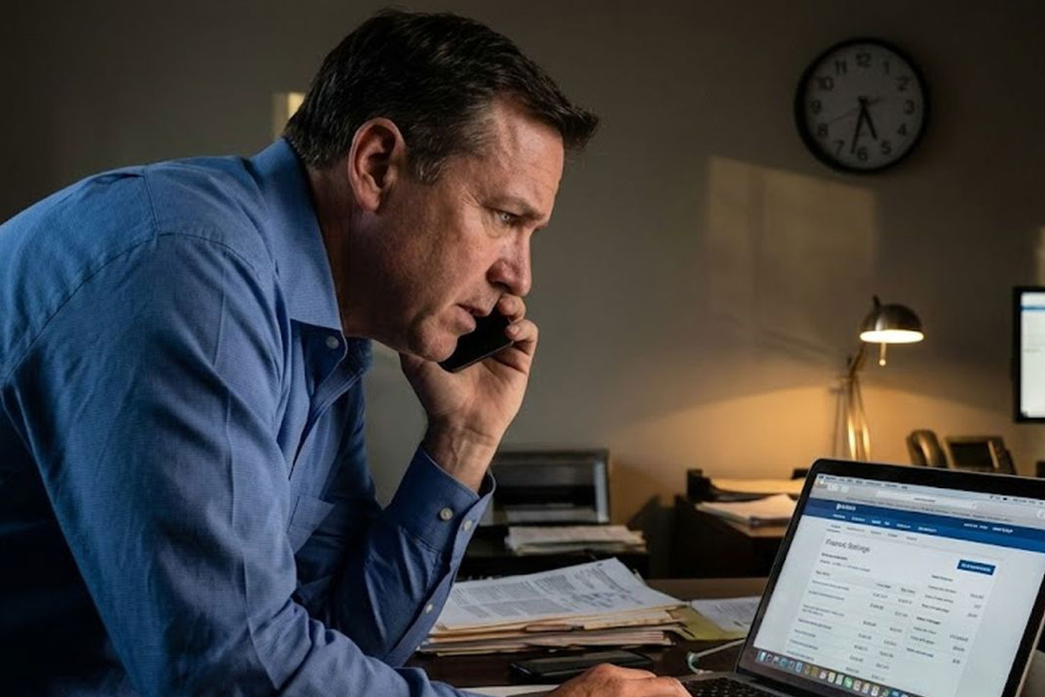 Business owner seeking emergency funding on laptop.