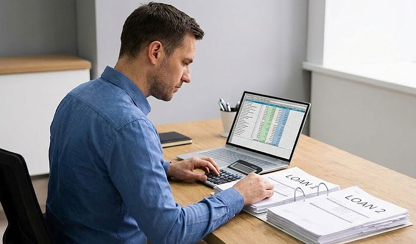 Business owner reviewing documents for second business loan.